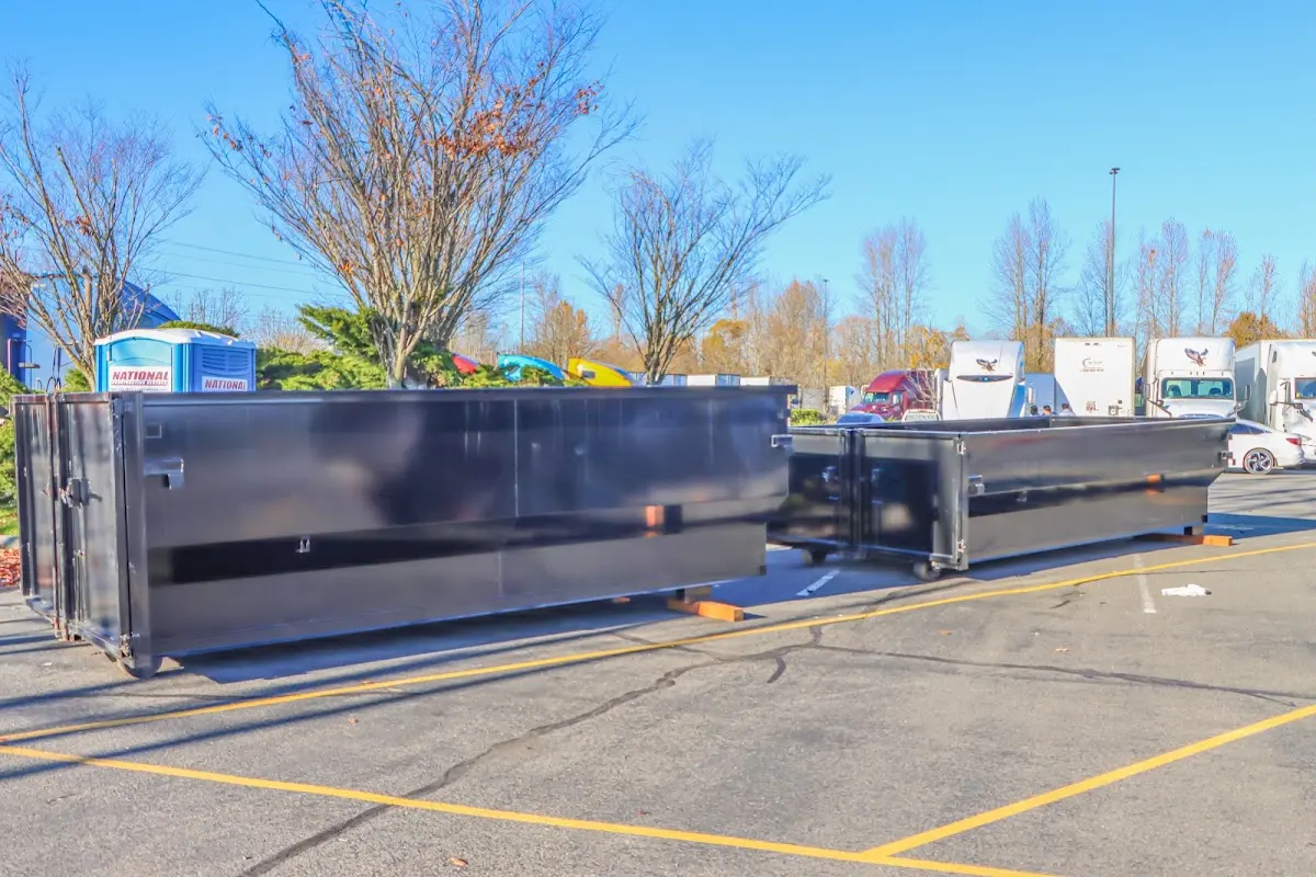 Professional dumpster rental service with roll-off container on residential driveway in Eugene